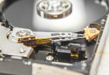 Cuánto dura un disco duro y cómo proteger tus datos Disco duro mecánico de ordenador abierto, con plato y componentes internos
